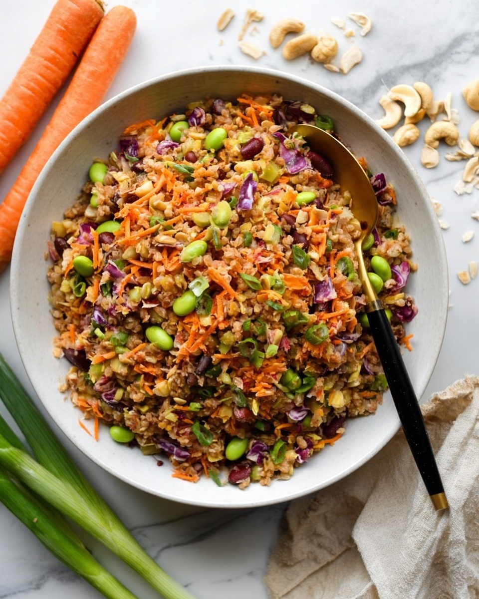The image shows a white bowl filled with a colorful mixed salad made from several layers of ingredients. The bottom layer is a mix of brown grains or seeds. On top of that are small pieces of orange shredded carrot, green edamame beans, and red beans, all mixed evenly. There are also bits of green onions and purple cabbage scattered throughout, adding more color and texture. A golden spoon with a black handle is resting in the bowl. The bowl is placed on a white marbled surface, with some whole carrots, green onions, cashew nuts, and uncooked grains scattered around it. The photo taken with an iphone --ar 2:3 --v 7