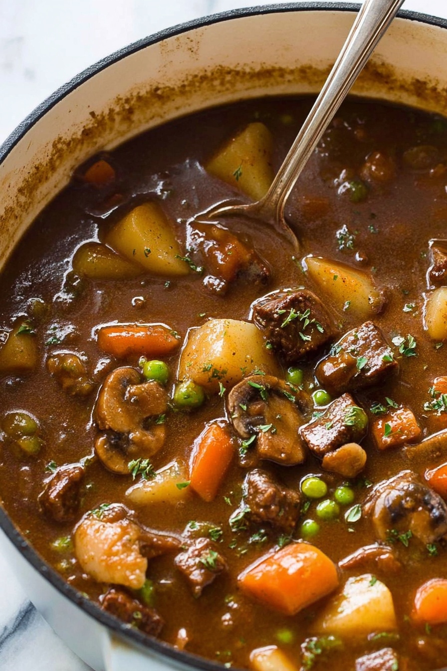 fall-apart beef and vegetable stew - The image shows a close-up of a pot filled with thick brown stew, with visible chunks of dark brown meat, light beige potatoes, orange carrots, green peas, beige mushrooms, and pieces of celery floating inside. The stew has a glossy, rich texture with some fresh green herbs sprinkled on top. A silver spoon is partially submerged in the stew, resting near the edge of the pot, which has a white exterior. The background is a white marbled surface. photo taken with an iphone --ar 2:3 --v 7