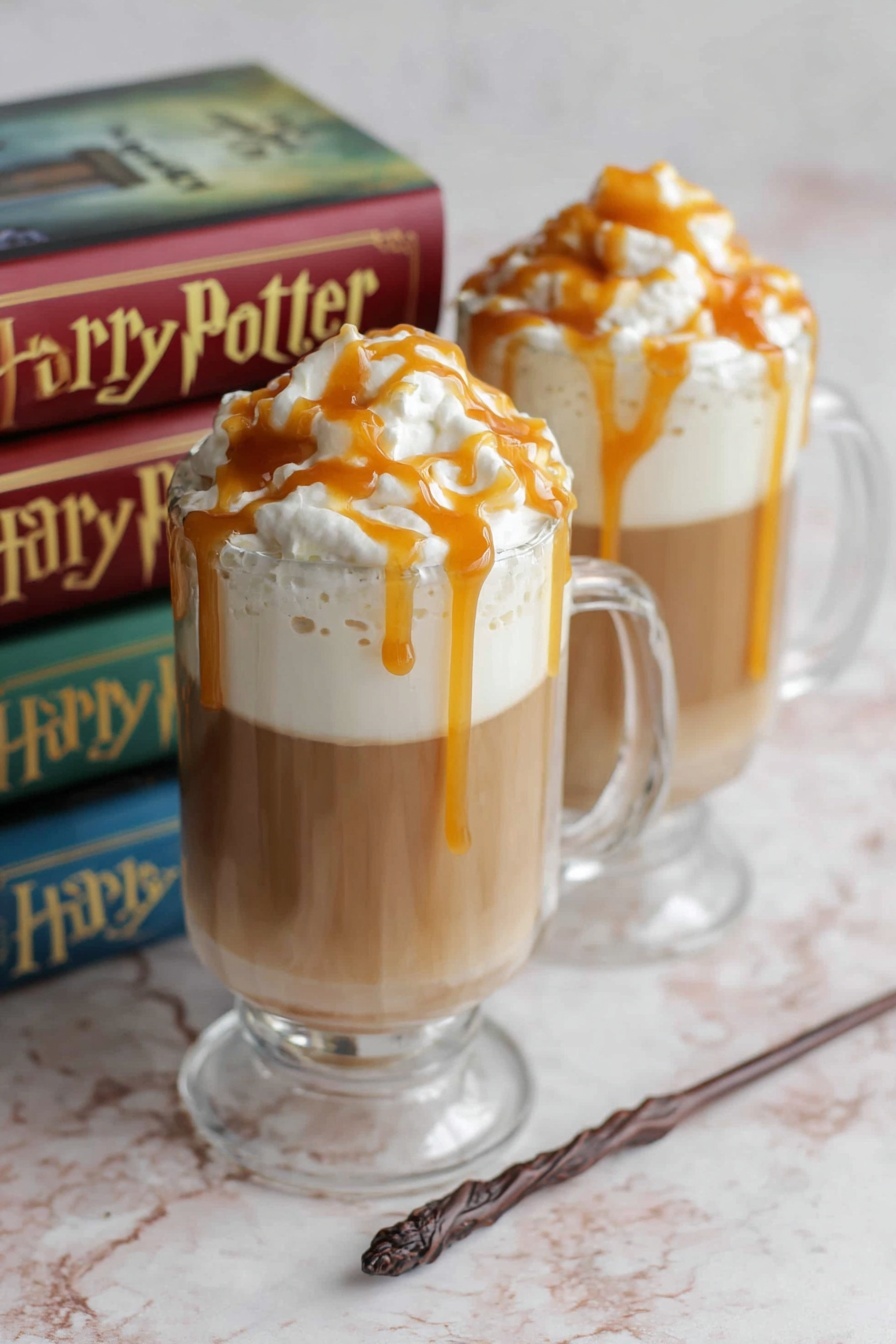 Two clear glass mugs filled with three layers: the bottom layer is light brown coffee, topped with a thick white foam layer, and finished with white whipped cream on top, drizzled with caramel sauce that lightly drips down the sides. The mugs sit on a white marbled surface with two Harry Potter books and a wand blurred in the background. Photo taken with an iphone --ar 2:3 --v 7