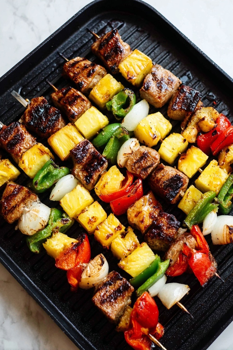 Several cooked skewers lay on a black grill pan placed on a white marbled surface. Each skewer has four main layers repeating in order: a chunky grilled brown meat piece with some charred edges, a bright yellow grilled pineapple cube with a slightly shiny texture, a green grilled pepper slice with a crisp texture, a piece of white grilled onion with slight translucency, and a red grilled bell pepper segment with visible grill marks. The colors alternate evenly, making the skewers look vibrant and well-cooked, with some pieces having a light caramelized surface. photo taken with an iphone --ar 2:3 --v 7