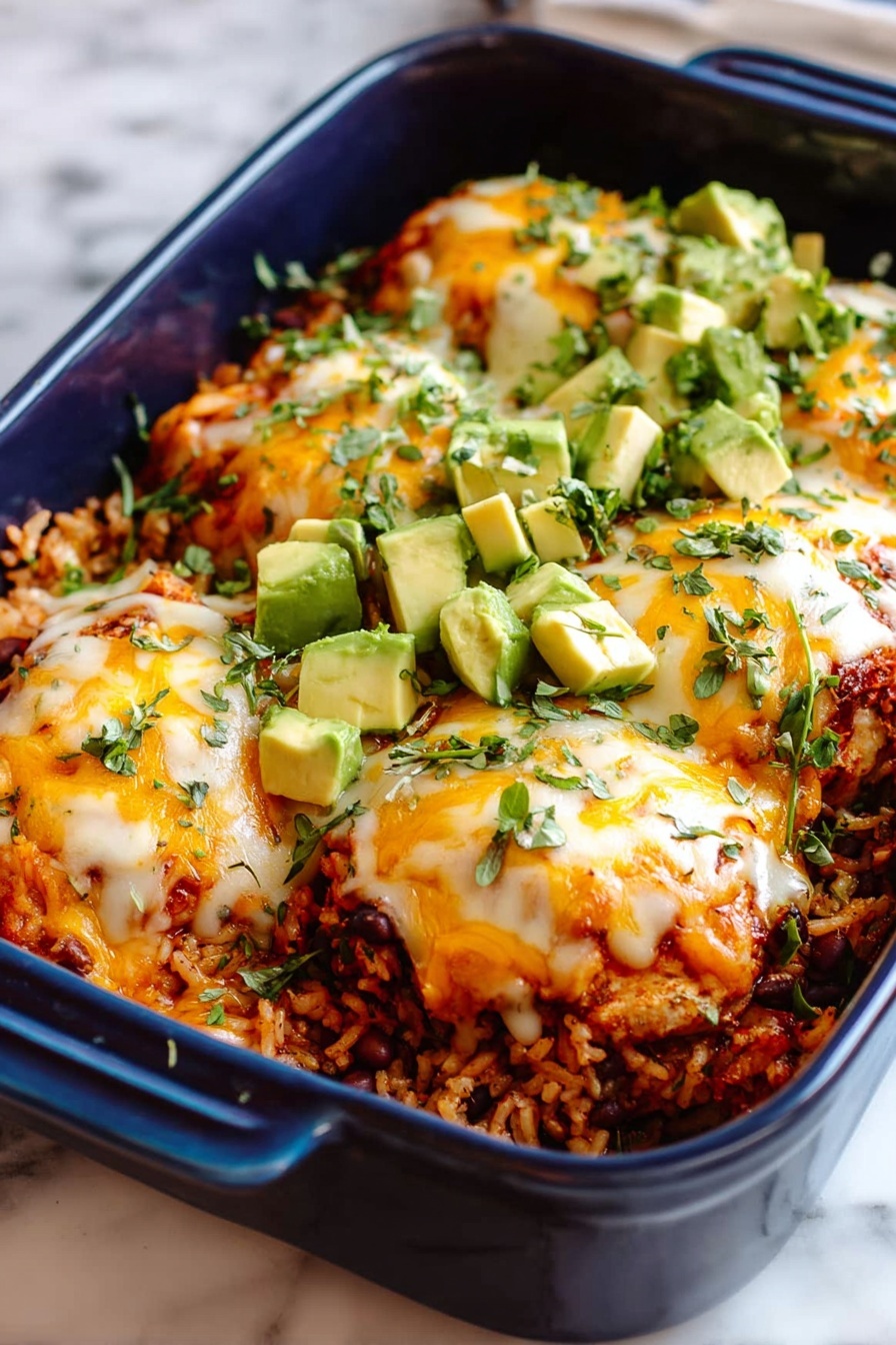 The image shows a dark blue baking dish filled with a layered casserole. The bottom layer is a mix of rice and beans, creating a grainy and textured base in light brown and dark tones. On top, there are four thick pieces of cooked chicken covered with melted white and orange cheese, which looks soft and slightly browned in parts. Fresh green avocado cubes are scattered on and around the chicken pieces. The dish is sprinkled with small green herb leaves, adding a fresh look. The background is white marble. Photo taken with an iphone --ar 2:3 --v 7