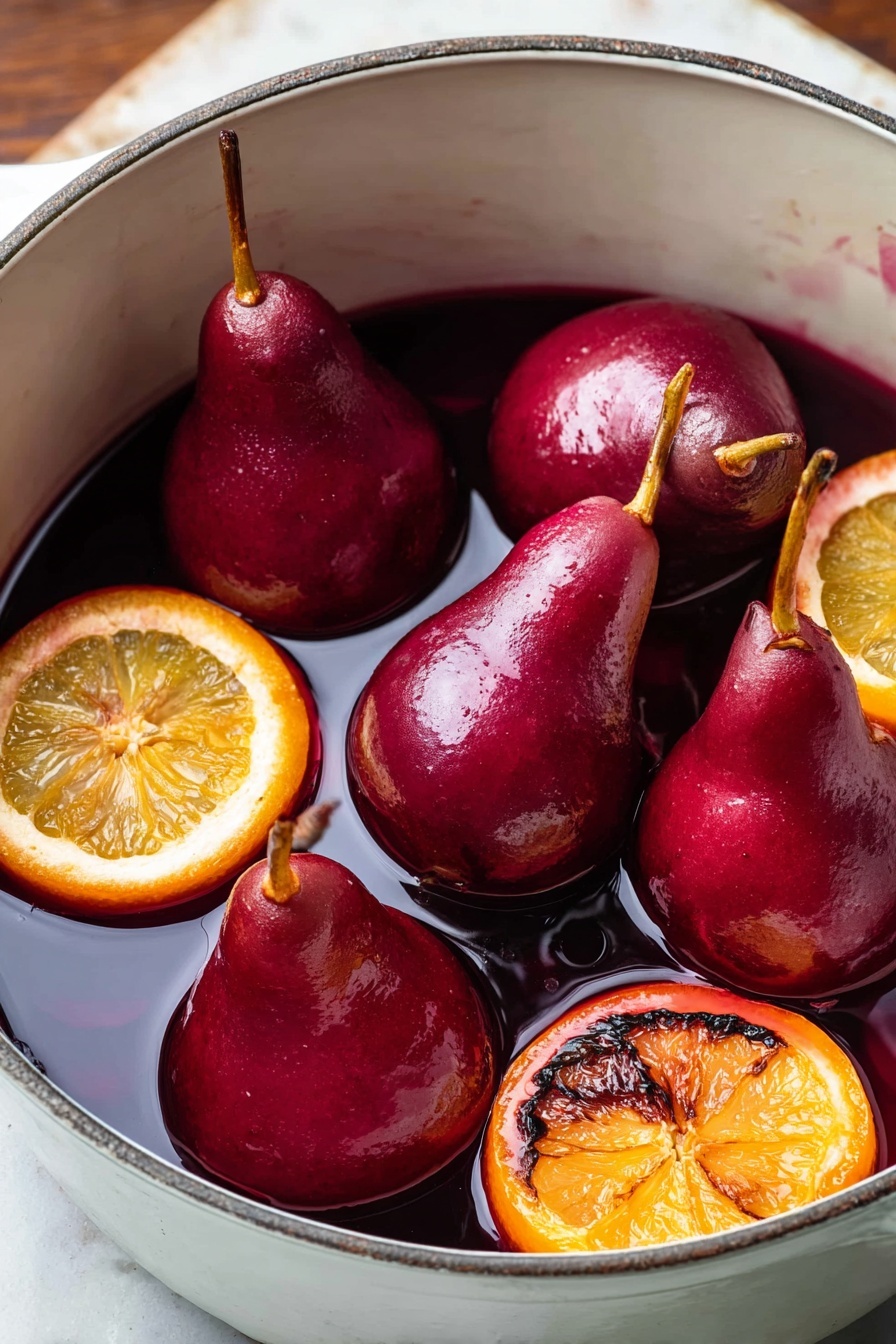 The image shows five whole pears that are deep red in color, sitting in a white pot filled with a dark red liquid, likely wine. The pears have their stems intact and are mostly submerged in the liquid. There are four slices of orange with a slightly charred texture floating among the pears, adding a bright orange contrast against the red and white. The pot has a smooth, white interior and is placed on a surface that is now imagined as white marbled texture. The scene is close-up, focusing on the rich colors and glossy textures of the pears and liquid. photo taken with an iphone --ar 2:3 --v 7