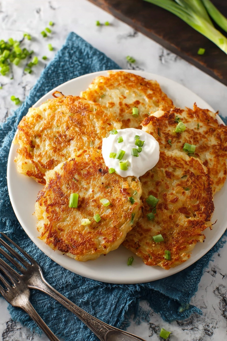 A clear glass bowl sits on a white marbled surface containing a thick, creamy mixture with a pale yellow color and slightly lumpy texture. A silver spoon is positioned in the bowl, partially covered with the mixture and resting near the side. The mixture appears dense and uneven, showing visible small chunks throughout its smooth but textured consistency. photo taken with an iphone --ar 2:3 --v 7