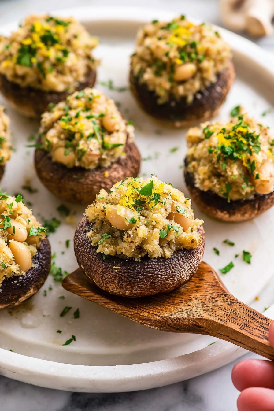 The image shows a close-up of a creamy mixture in a white bowl on a white marbled surface. The mixture has three main colors: white creamy base, bits of light brown nuts or seeds, and green bits of herbs evenly mixed throughout. A white spatula with a wooden handle is partially in the bowl, stirring the mixture. The texture looks thick and slightly chunky with visible small pieces. The photo is bright and clear, focusing tightly on the bowl's contents. Photo taken with an iphone --ar 2:3 --v 7