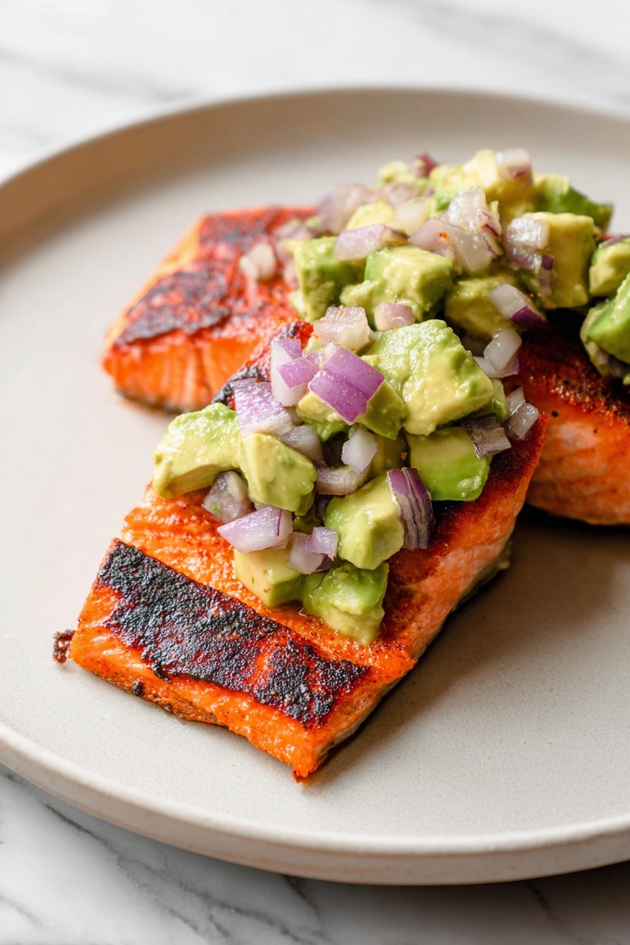A clear glass bowl on a white marbled surface filled with a salad made up of three layers: large chunks of green avocado with soft texture, small pieces of purple red onion with a smooth texture, and tiny bits of green leafy herbs mixed throughout. The ingredients are mixed and show a slight shine from dressing or juice, giving the salad a fresh and juicy look. Photo taken with an iphone --ar 2:3 --v 7